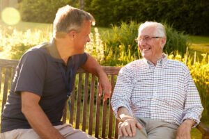 Family member reviews a HIPAA authorization form with an older adult at an assisted living table.